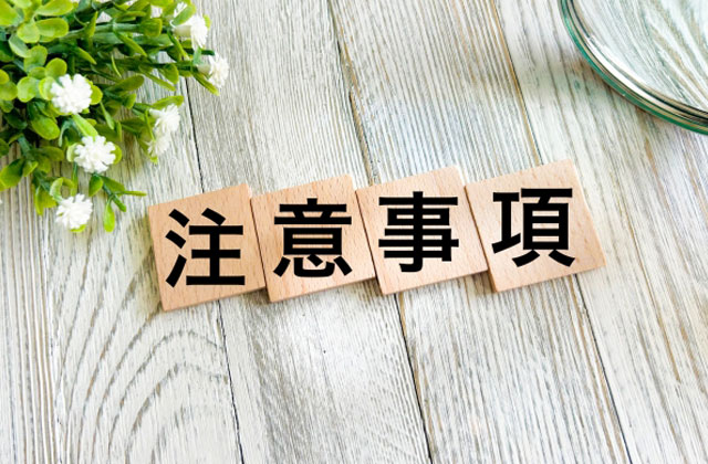 注意点と書かれたブロックと植物