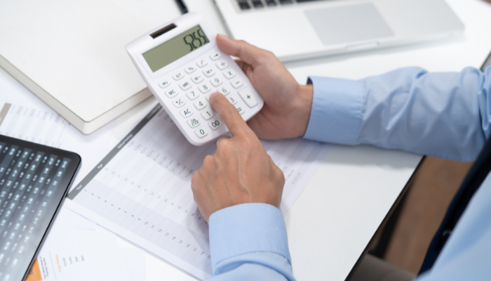 リビングリフォームの金額を計算する男性の手元